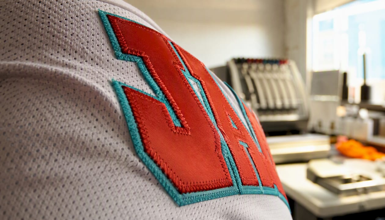 Tackle twill letters sewn on baseball jersey fabric