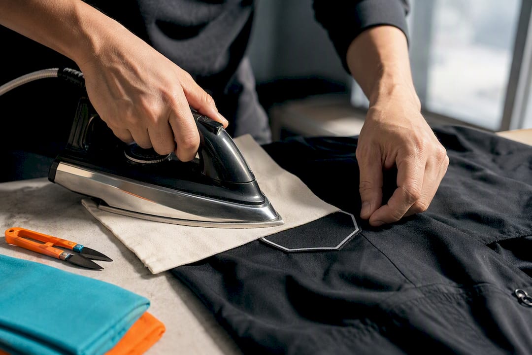 Hands repairing a lifted heat-seal patch