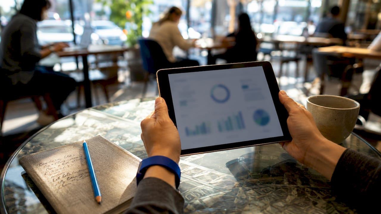 Hands holding tablet showing job matching data