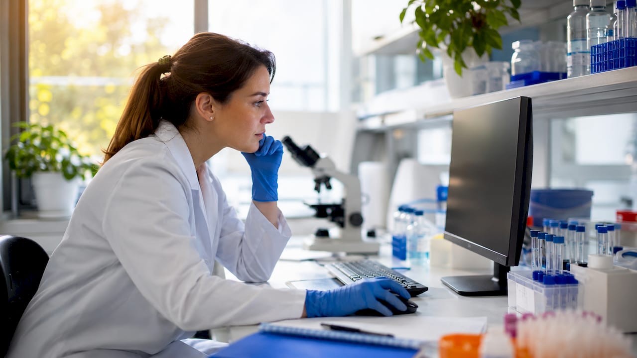 Scientist reviewing DNA test data in lab