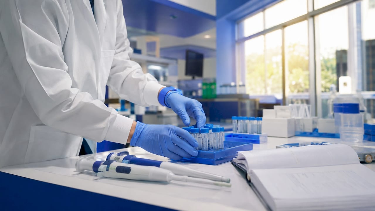 Technician handling DNA test samples in lab