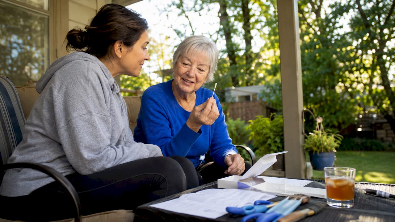Grandmother and daughter unpacking DNA test kit