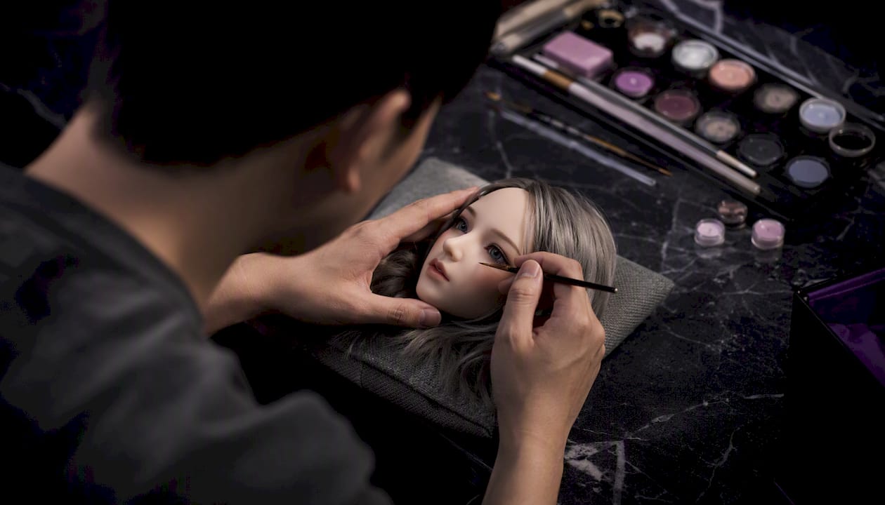 Artist painting detailed doll facial features