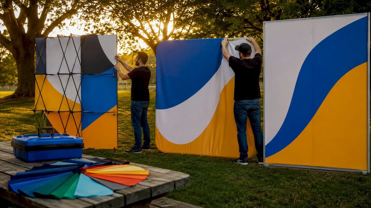 Hands assembling different exhibition backdrop types