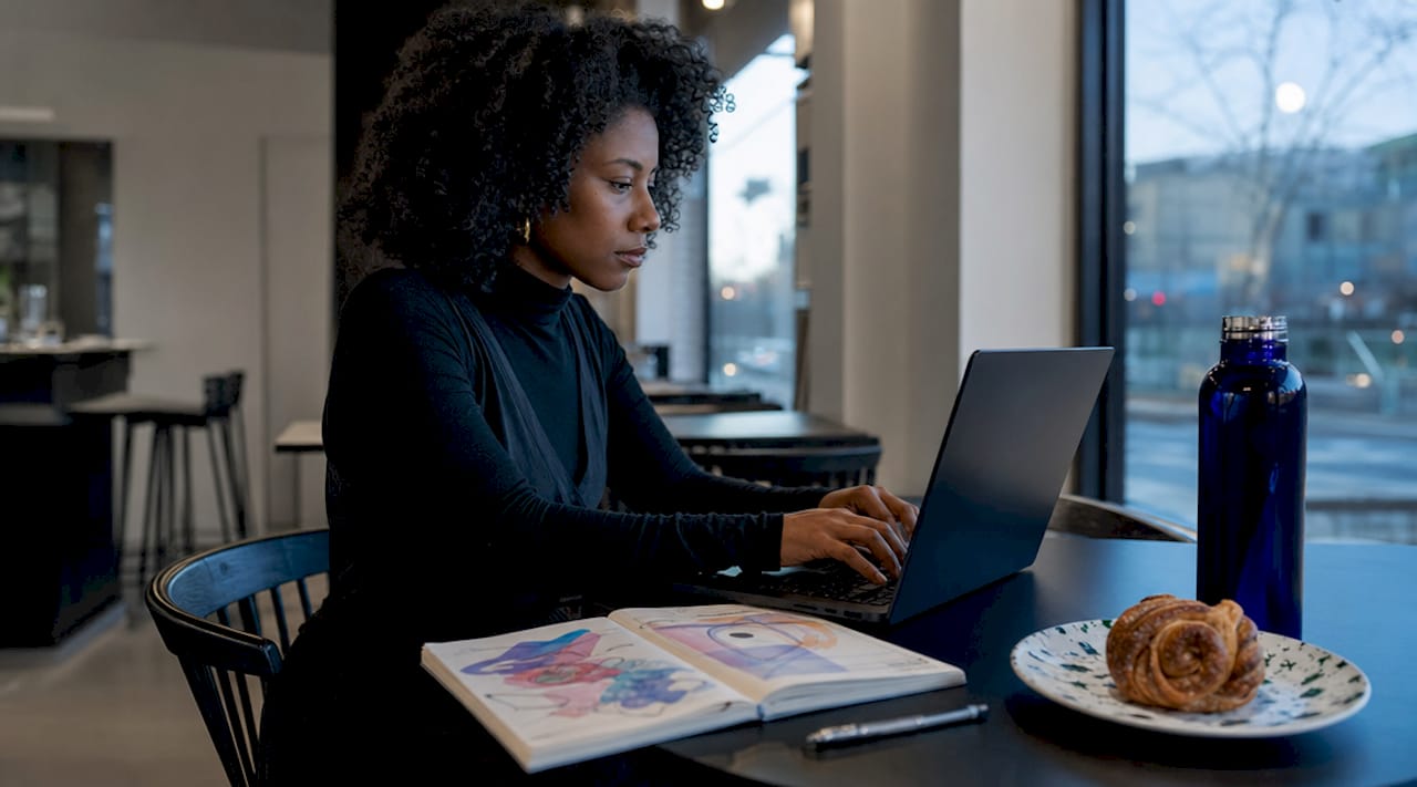 Hands typing specific collaboration pitch on laptop