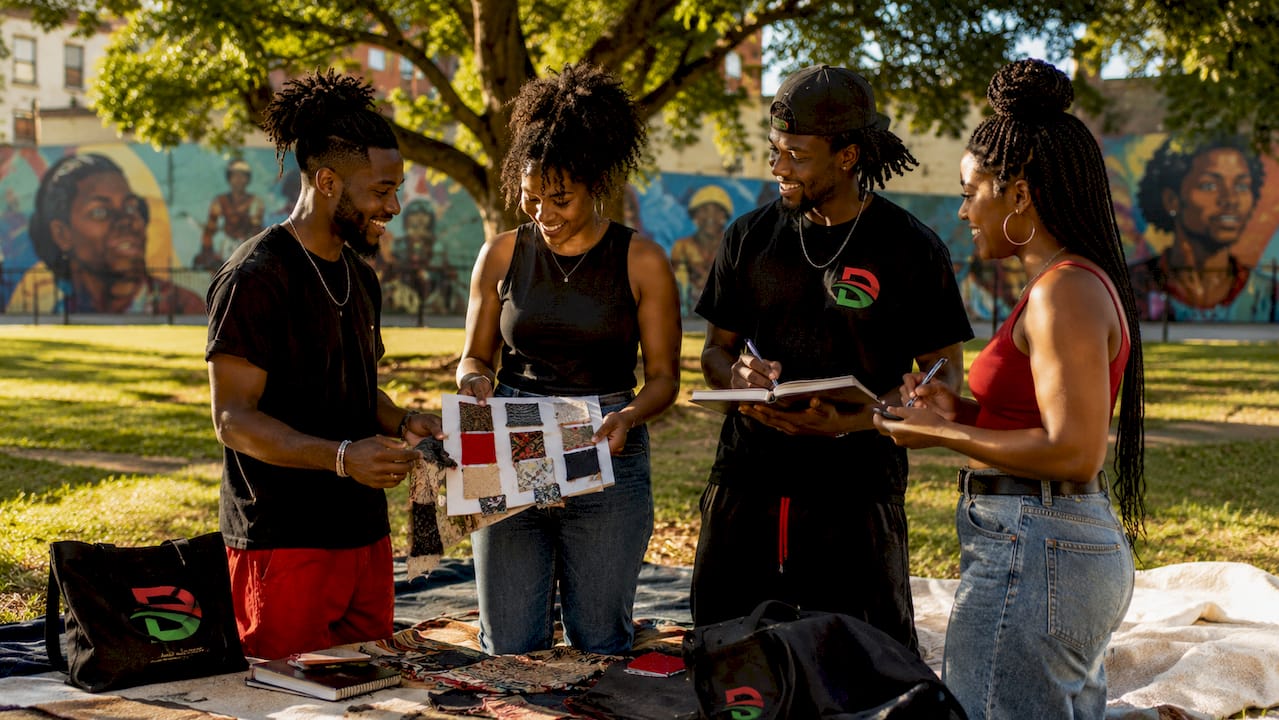 Diverse Black creatives collaborating outdoors