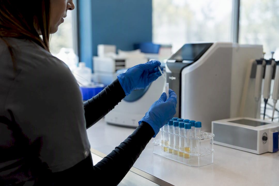 Hands handling toxicology samples in lab