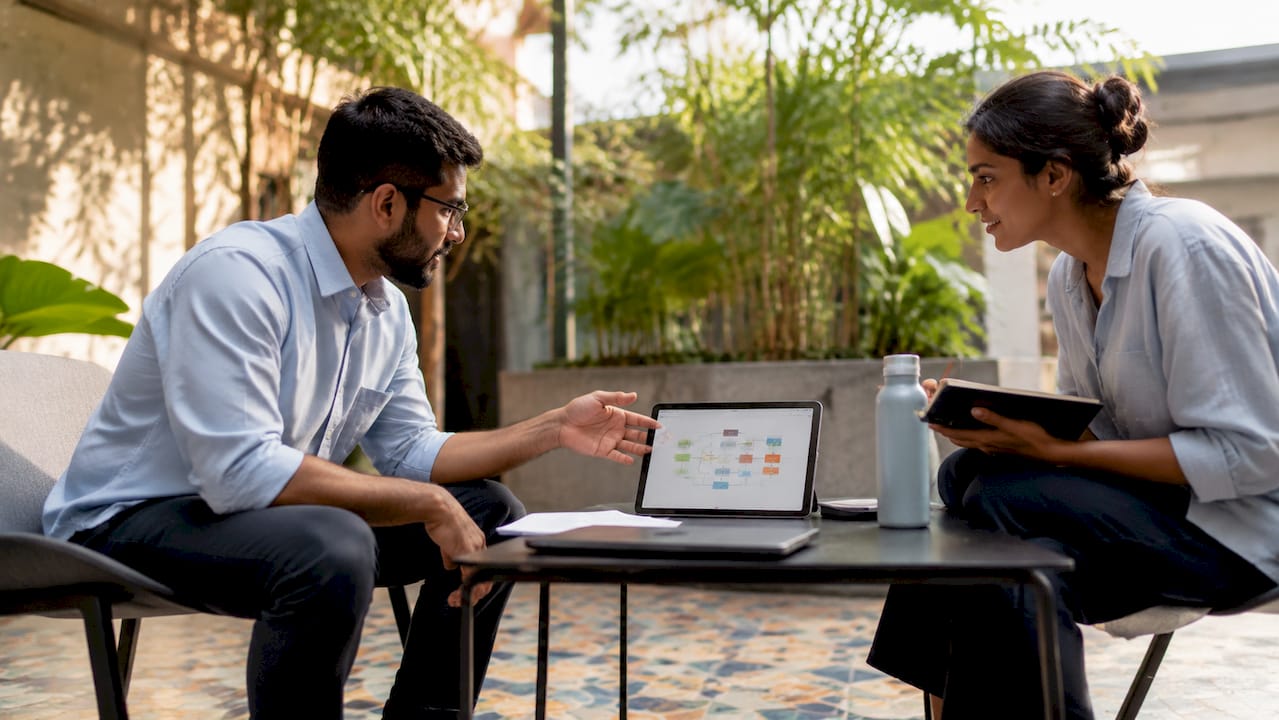 Two engineers discussing CI/CD deployment steps
