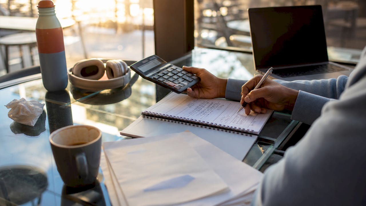 Hands calculating development cost savings