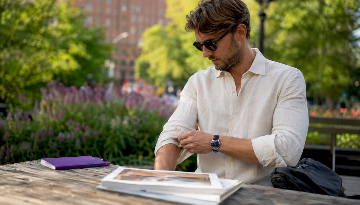 Hands adjusting linen shirt sleeve outdoors