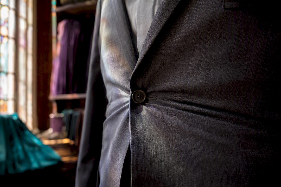 Suit jacket top button straining on fabric