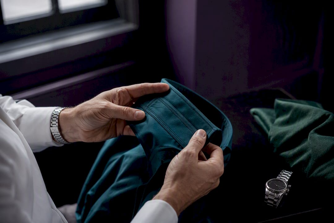 Hands checking double-needle stitched cuff seam