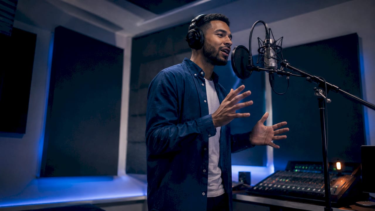 Voice actor performing in recording booth
