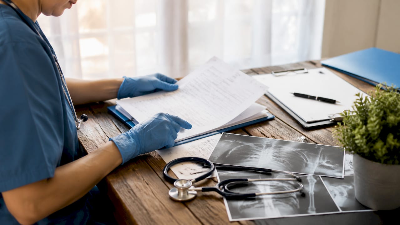 Healthcare professional reviewing medical records