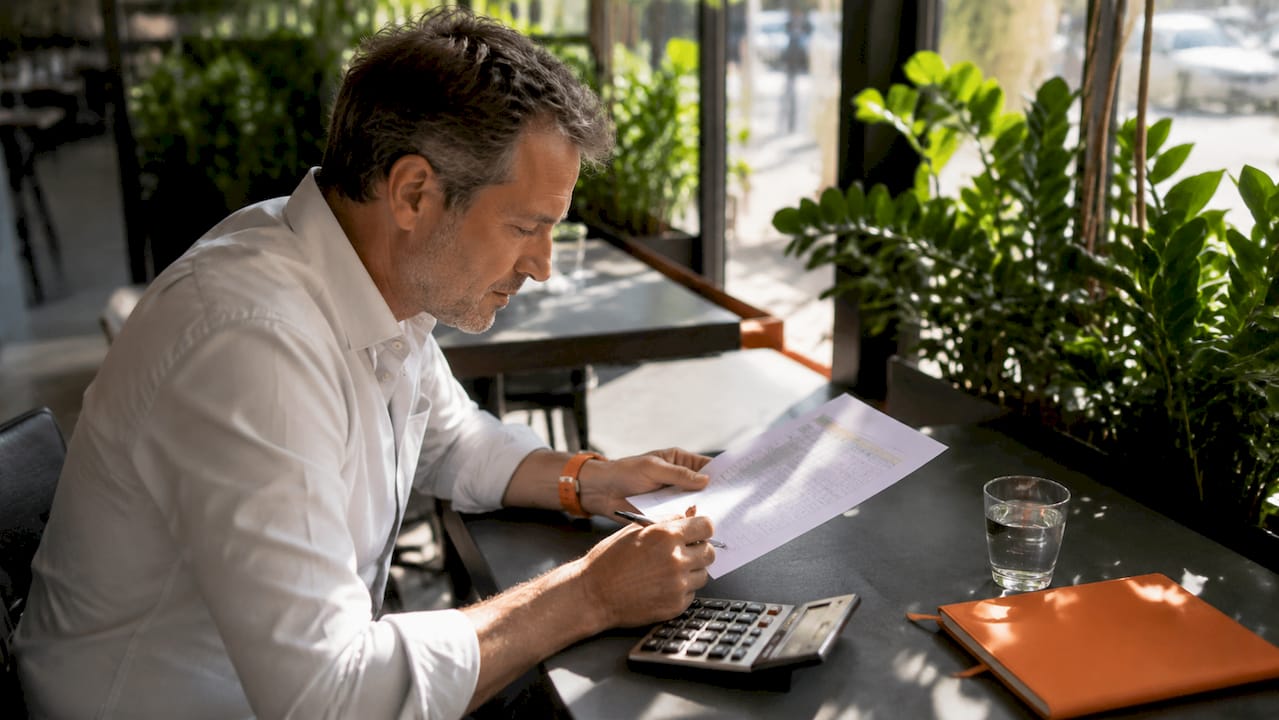 Broker reviewing customs cost savings spreadsheet