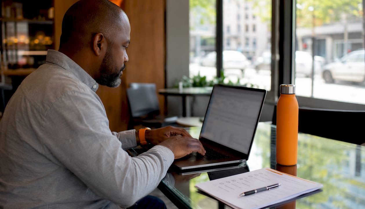 Man checking shipment tracking on laptop