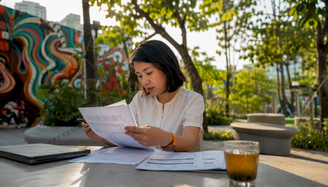 Woman reviewing China freight forwarding alternatives paperwork