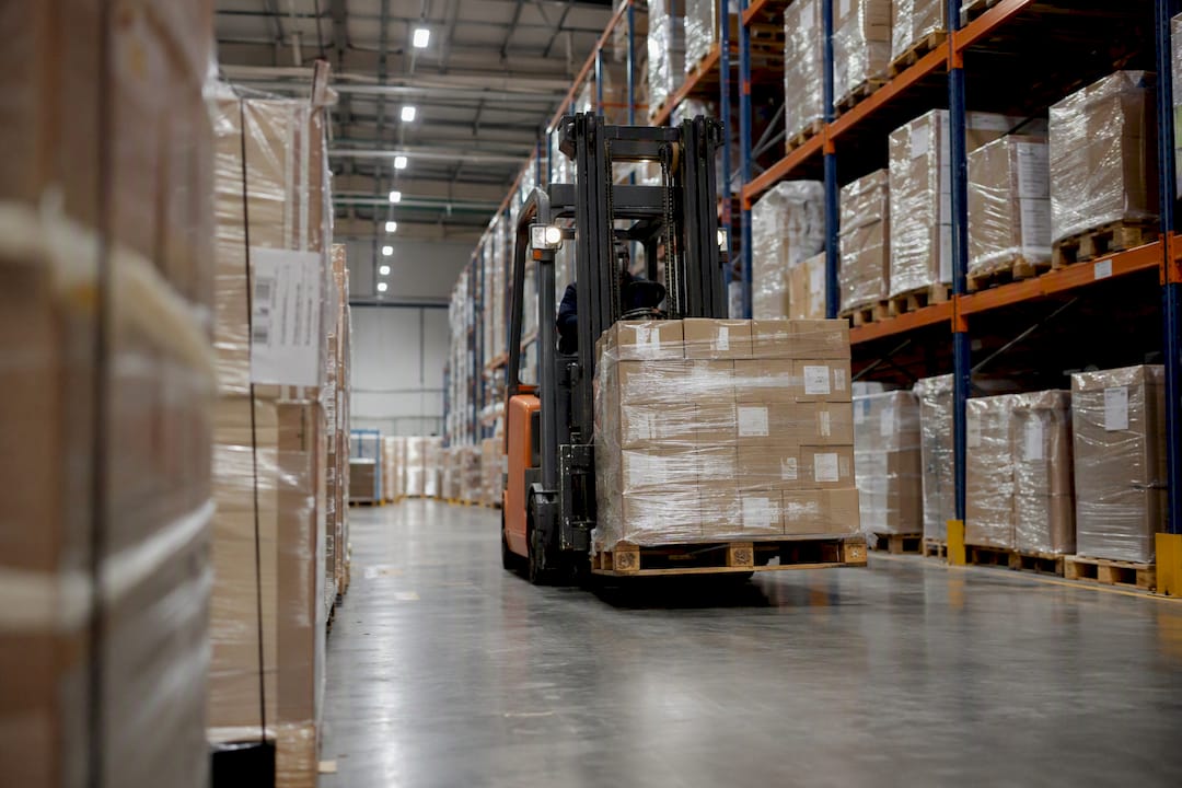 Forklift moving pallets in bonded warehouse
