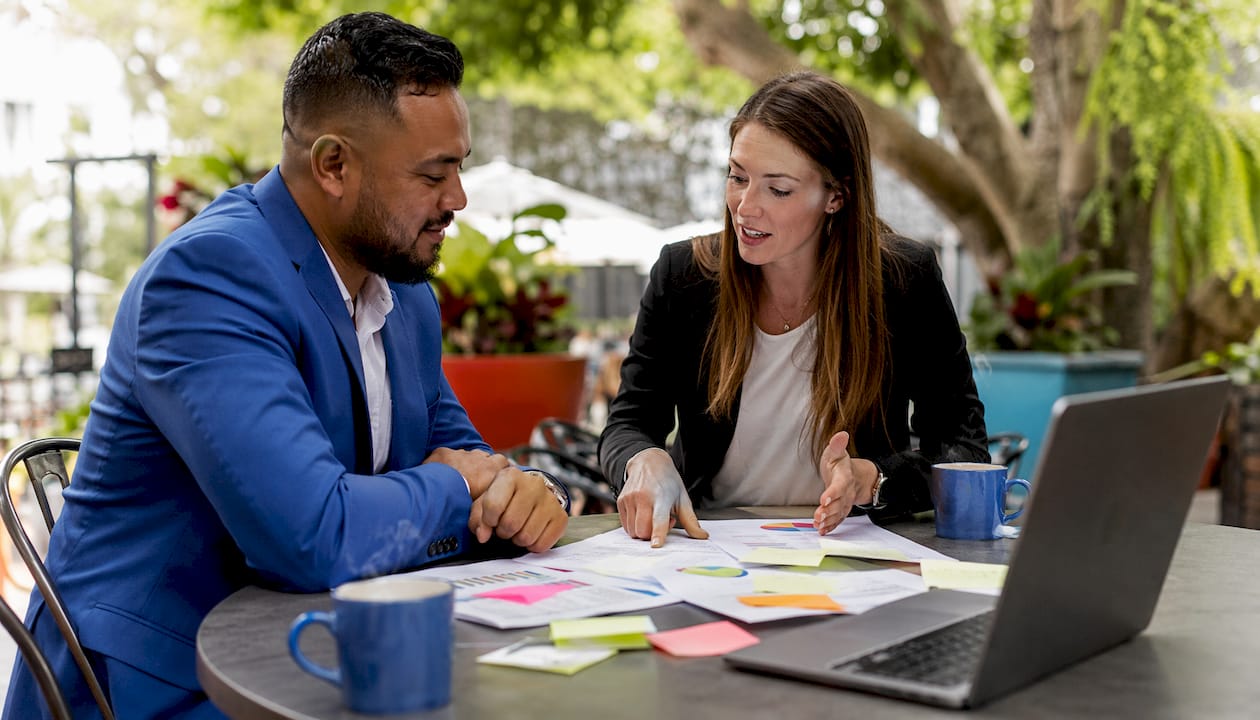 Two professionals discussing lead generation