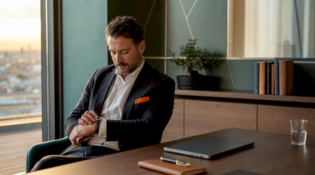 Leader pausing thoughtfully at desk