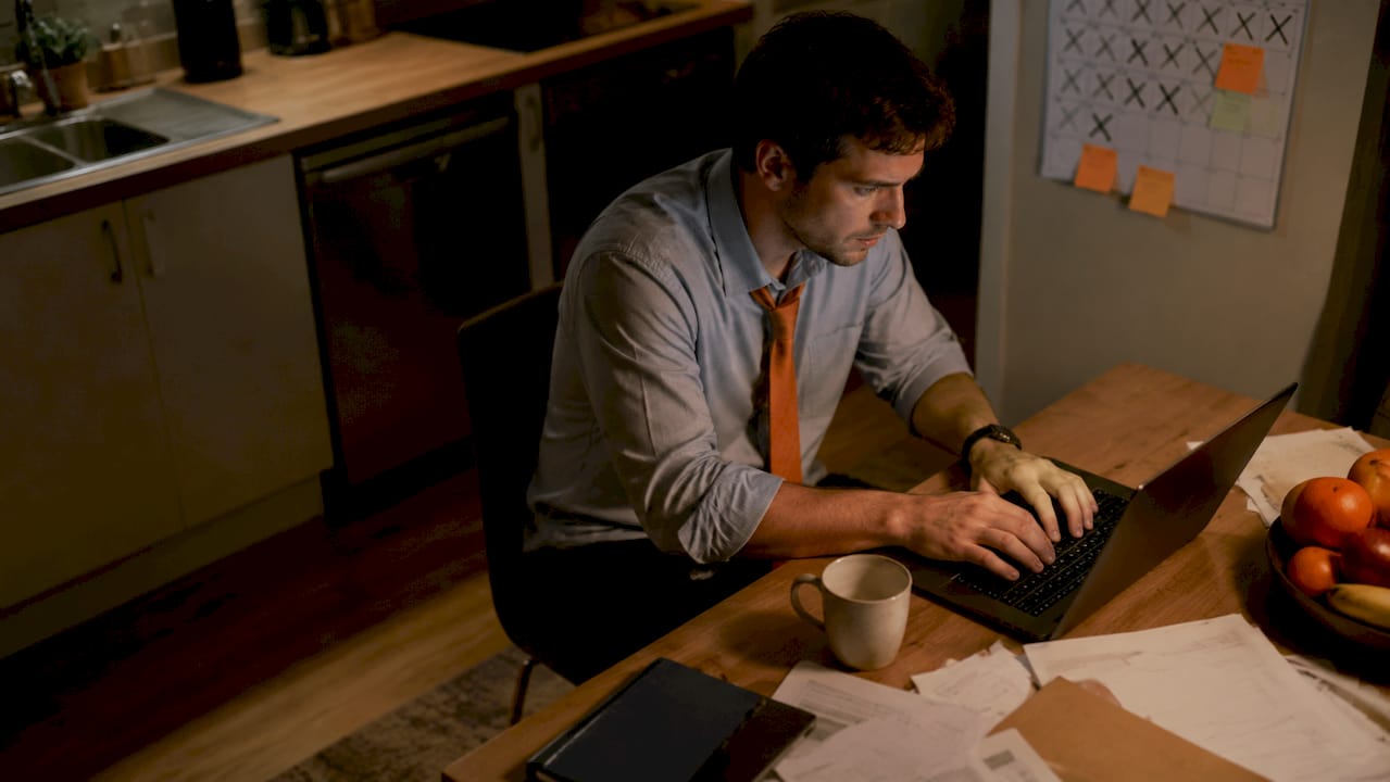 Tired new manager working late at cubicle