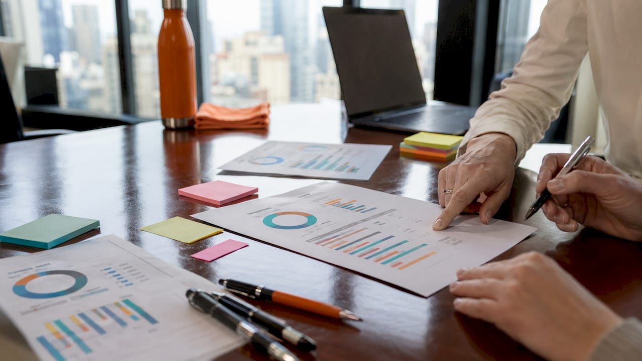 Hands reviewing 360-degree feedback reports