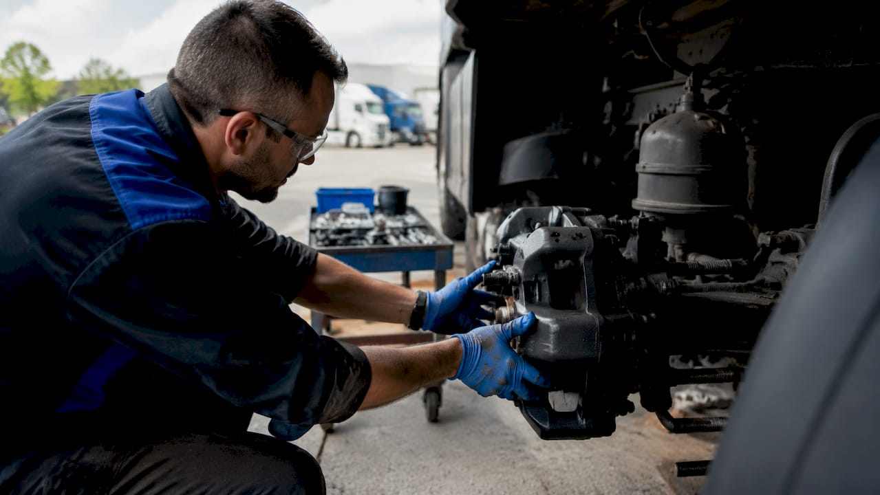 Technician replacing Haldex brake part on truck