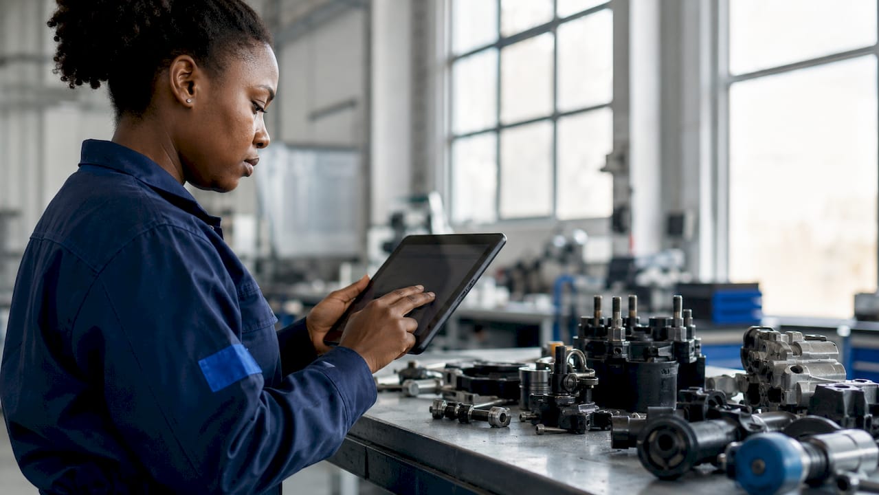 Technician reviewing digital quality control data on tablet