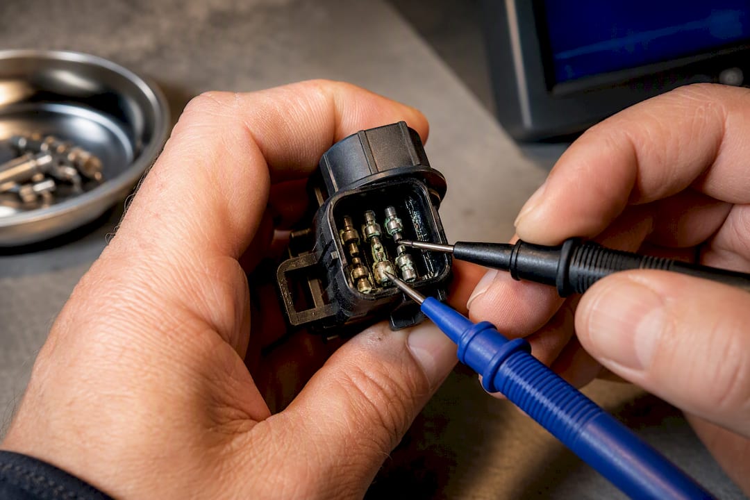 Corroded solenoid contacts tested with probes