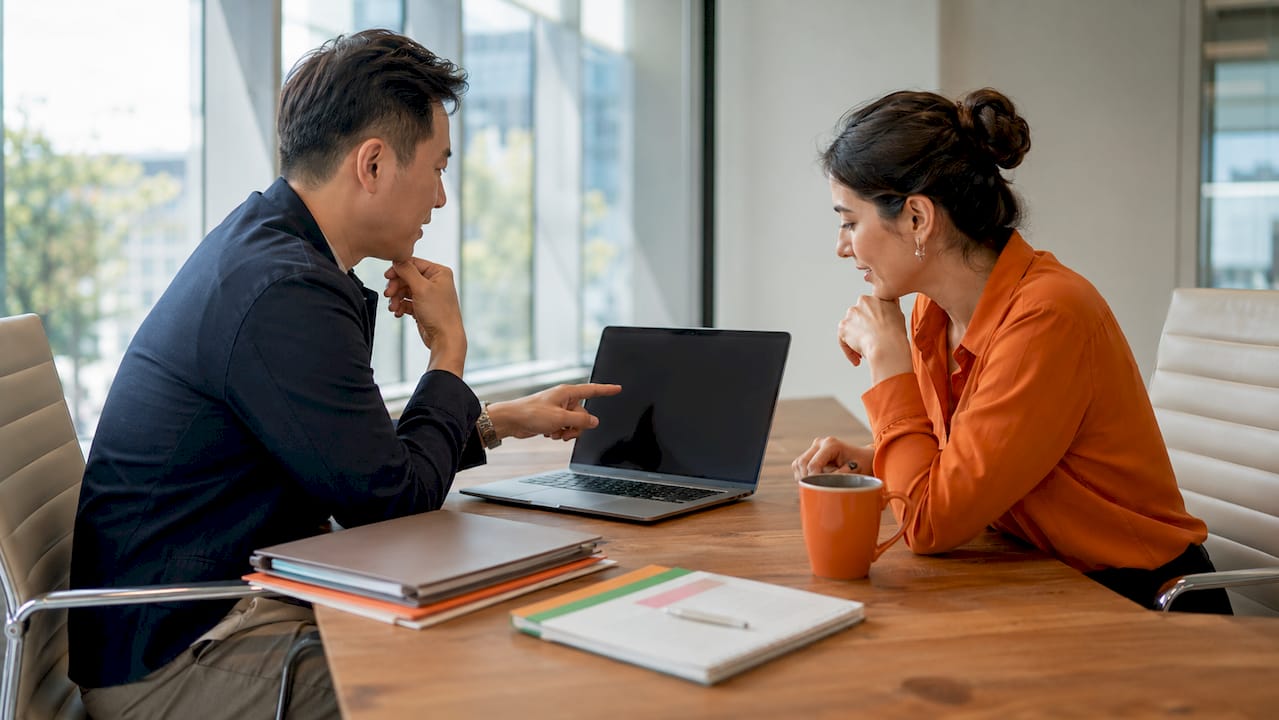 Colleagues discussing job requisition on tablet