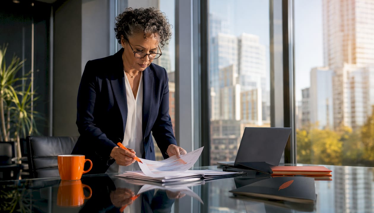 CIO reviewing operation reports at desk