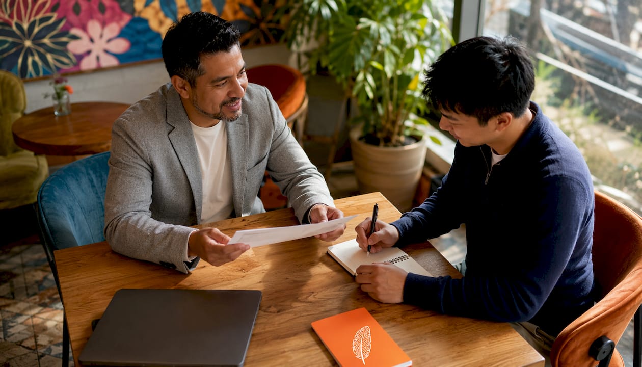 Career coach consulting IT job seeker in coworking space