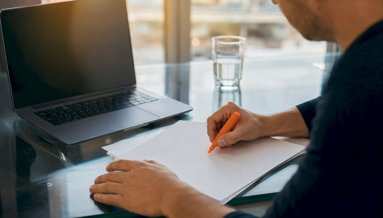 Hands poised to edit resume bullet point