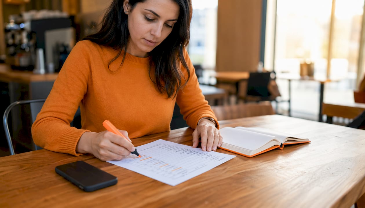 Hands holding legal PPC keyword printout