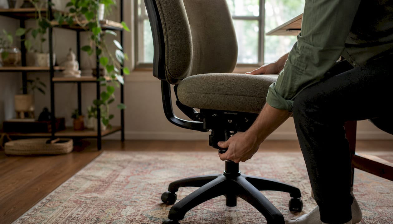 Hands adding cushion to office chair seat