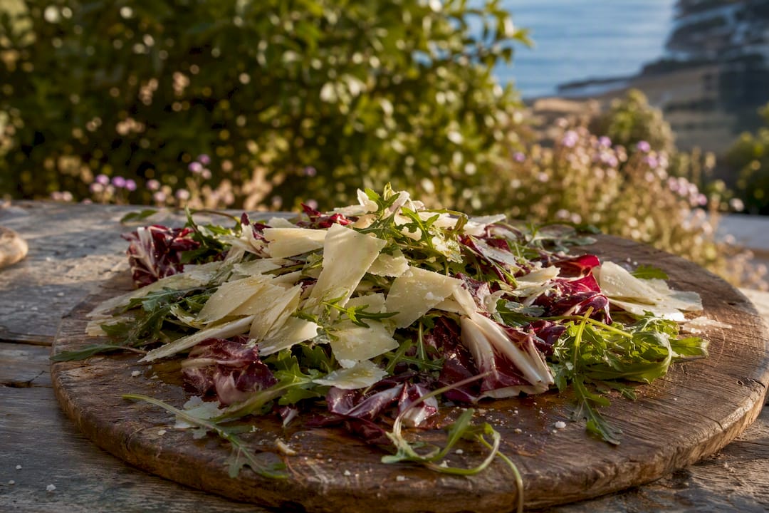 Plate with parmesan and bitter greens