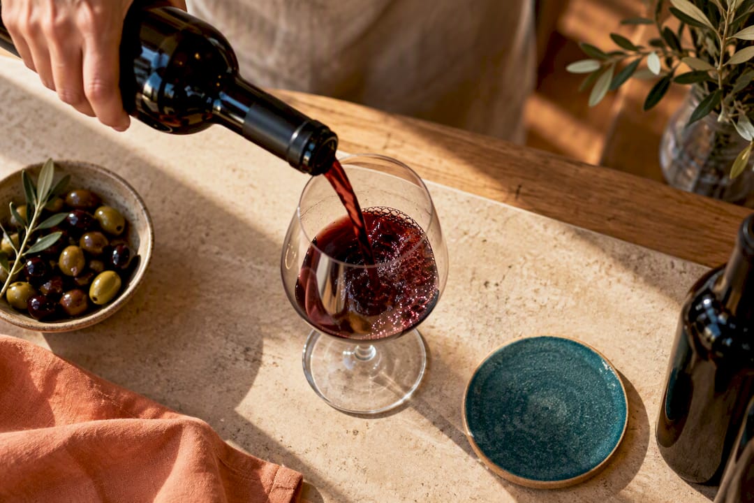 Red wine poured into tasting glass