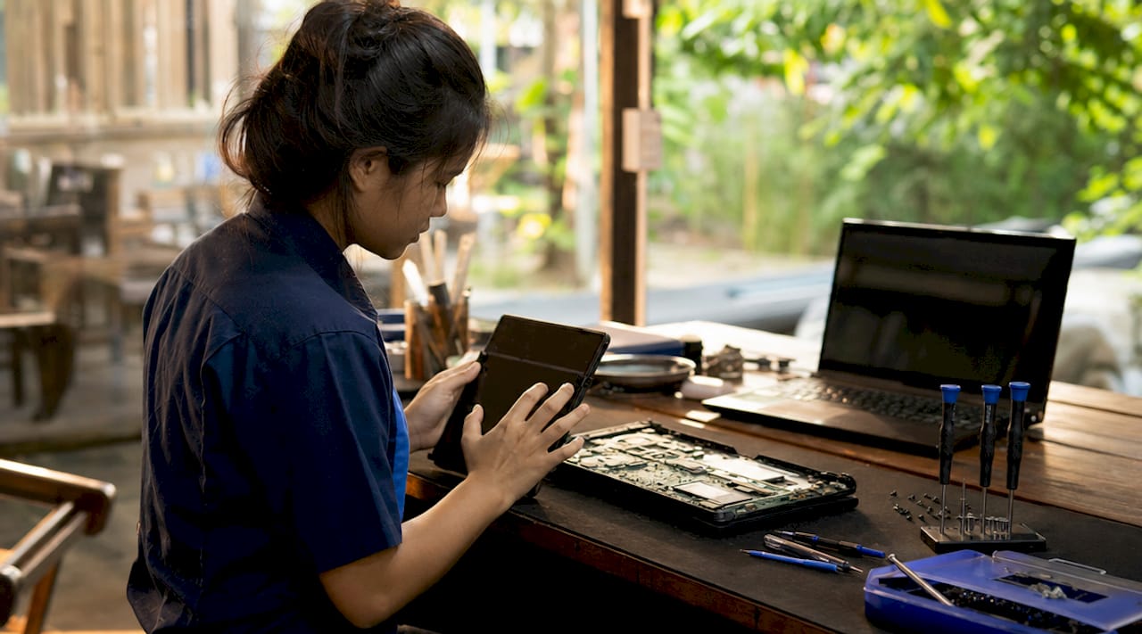 Technician hands operating diagnostic tool tablet