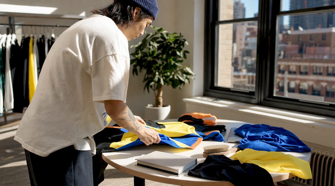 Stylist preparing apparel products on table
