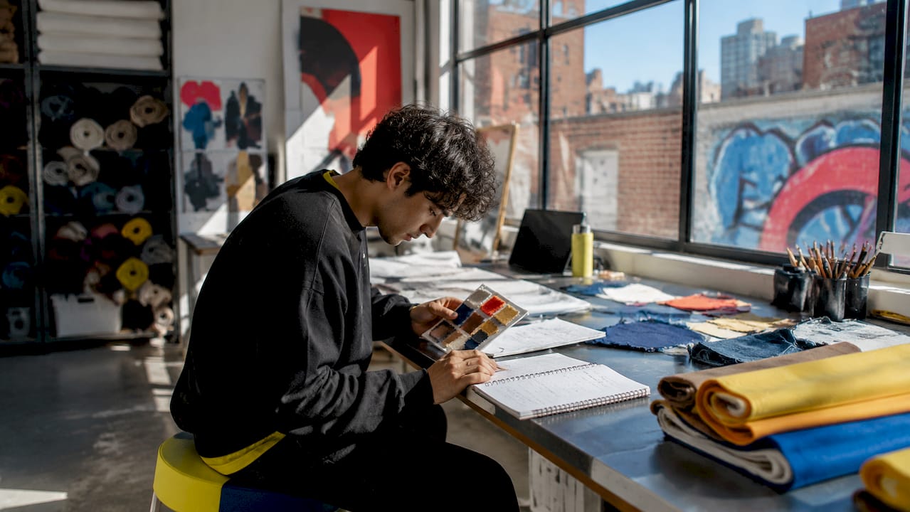 Hands checking fabric samples and minimum order notes