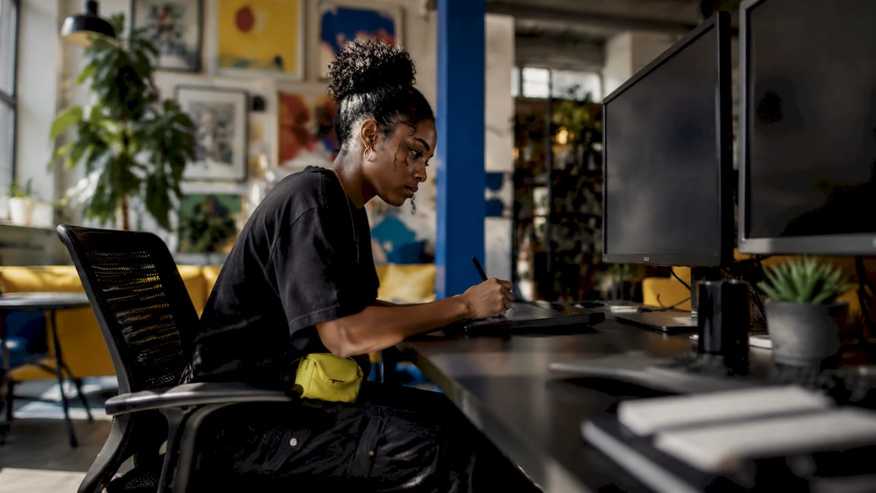 Designer working on t-shirt mockup on digital tablet