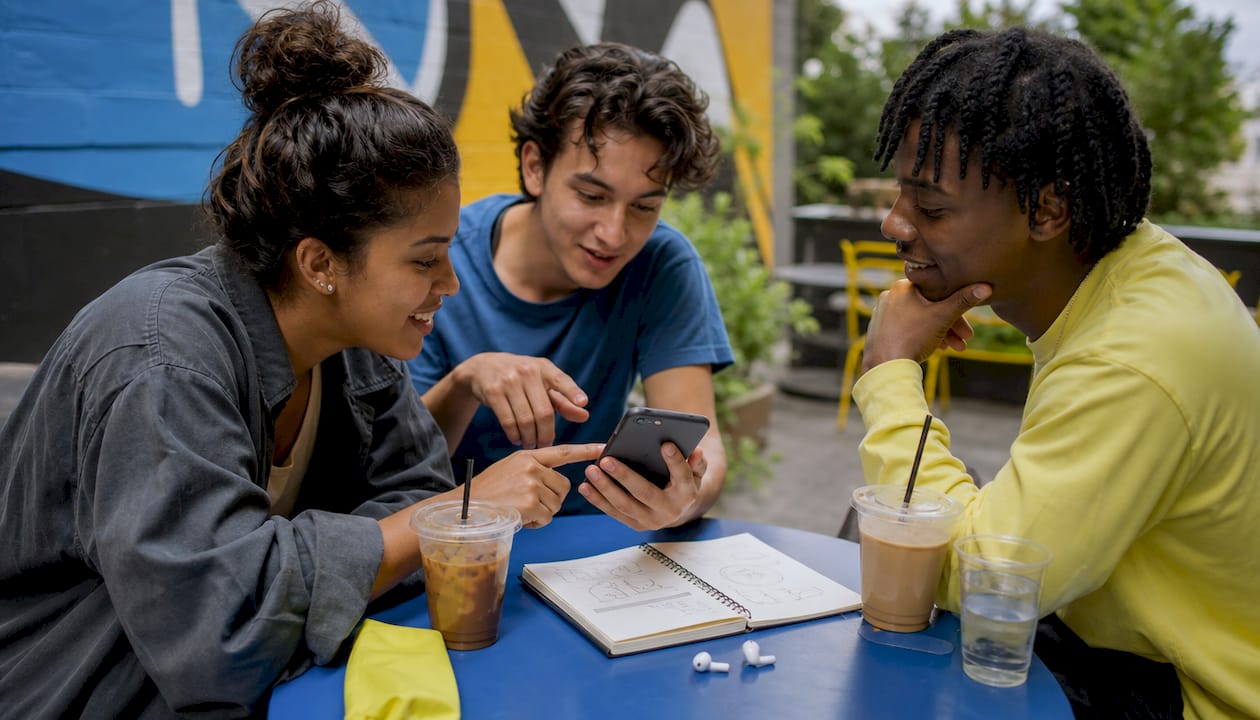 Hands holding smartphone creating video content