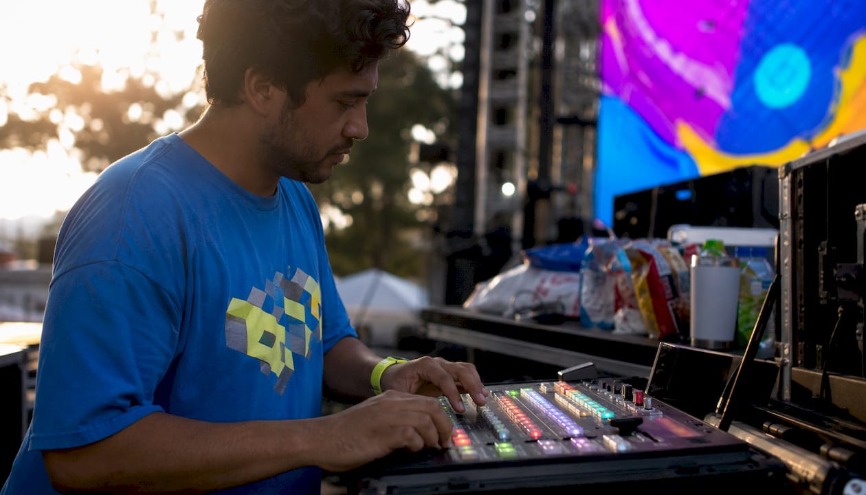 Hands adjusting video switcher during event