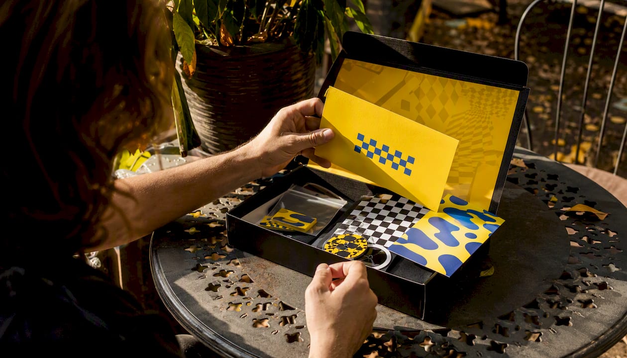 Hands unpacking a branded onboarding kit