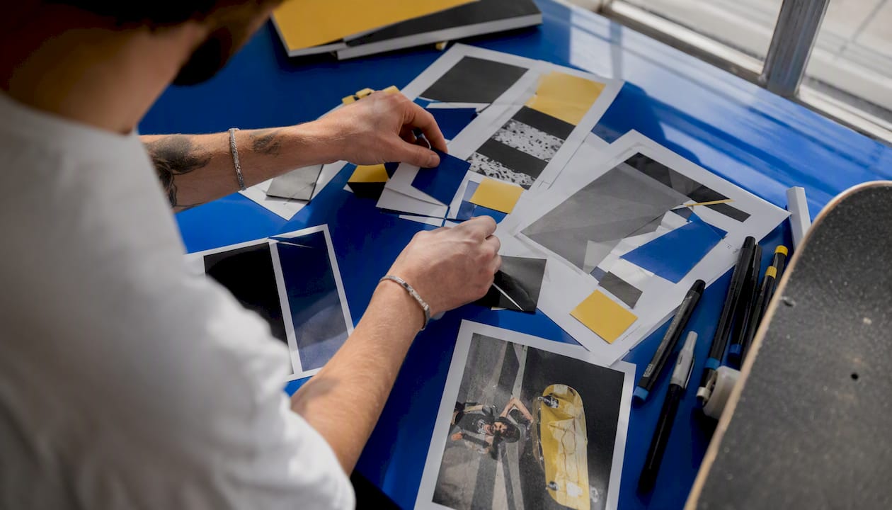 Hands arranging creative campaign materials