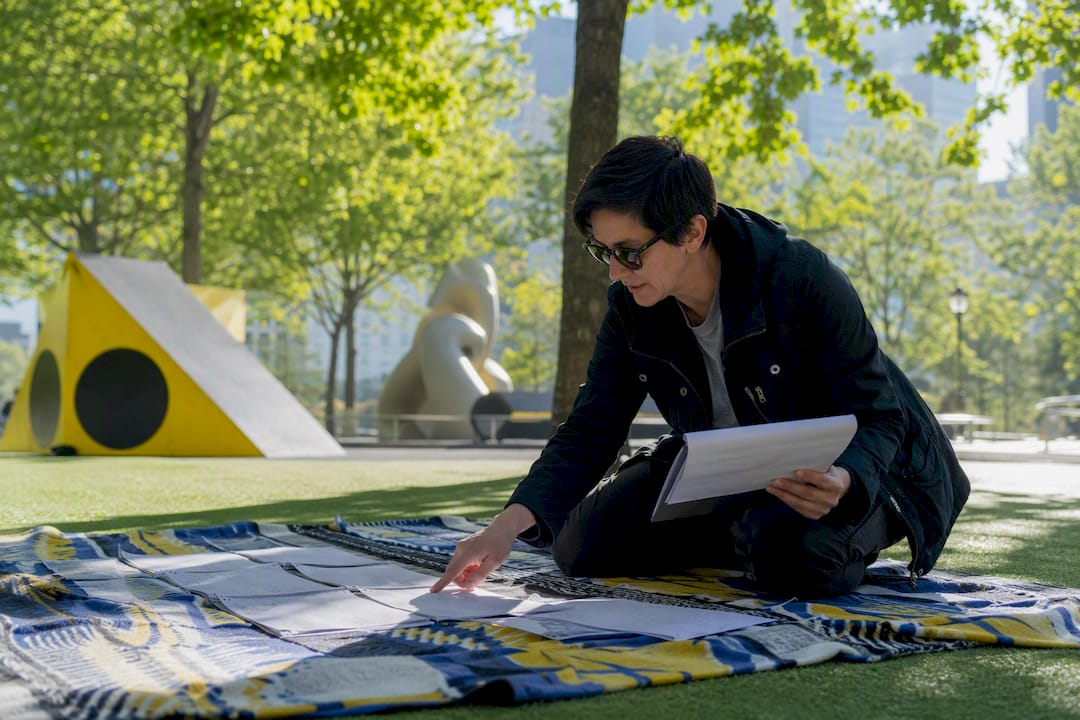 Person comparing storyboard and shot list on location