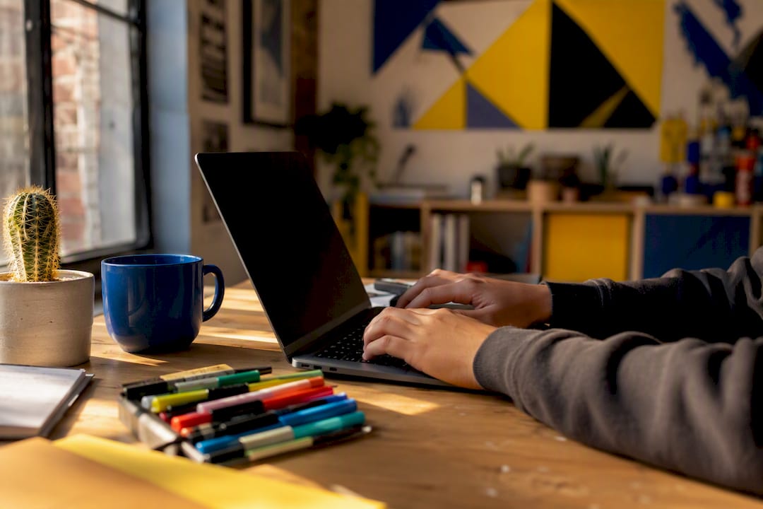 Hands updating digital rights ledger on desk
