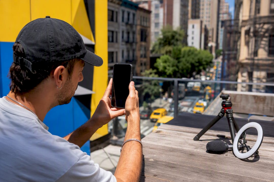 Hands filming short video on smartphone