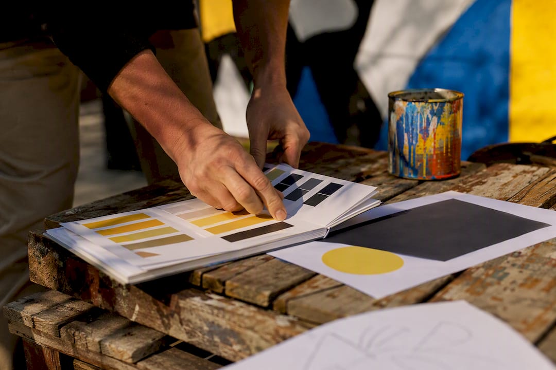 Hands arranging brand color and logo samples