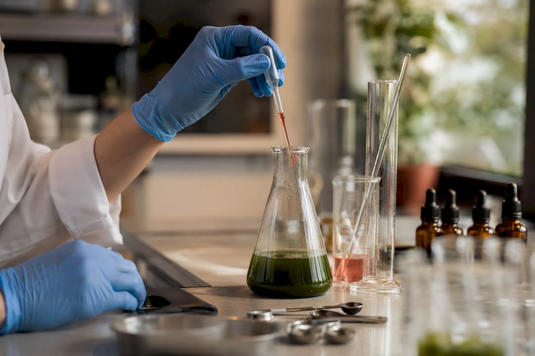 Lab pouring liquid in hemp extract conversion